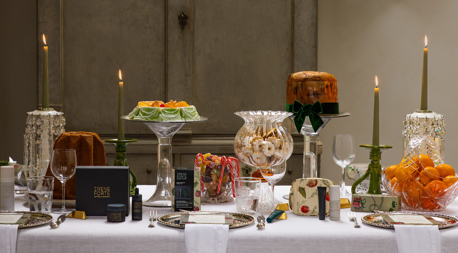 Elegant table setting with candles, glassware, and decorative items in a formal dining room.